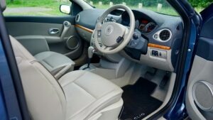 Explore the detailed view of a car interior featuring a modern steering wheel and dashboard.